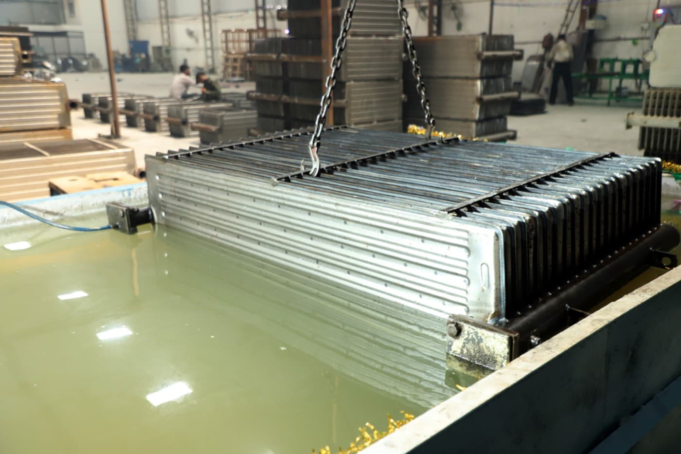 Radiator assembly submerged in the leak and pressure test tank